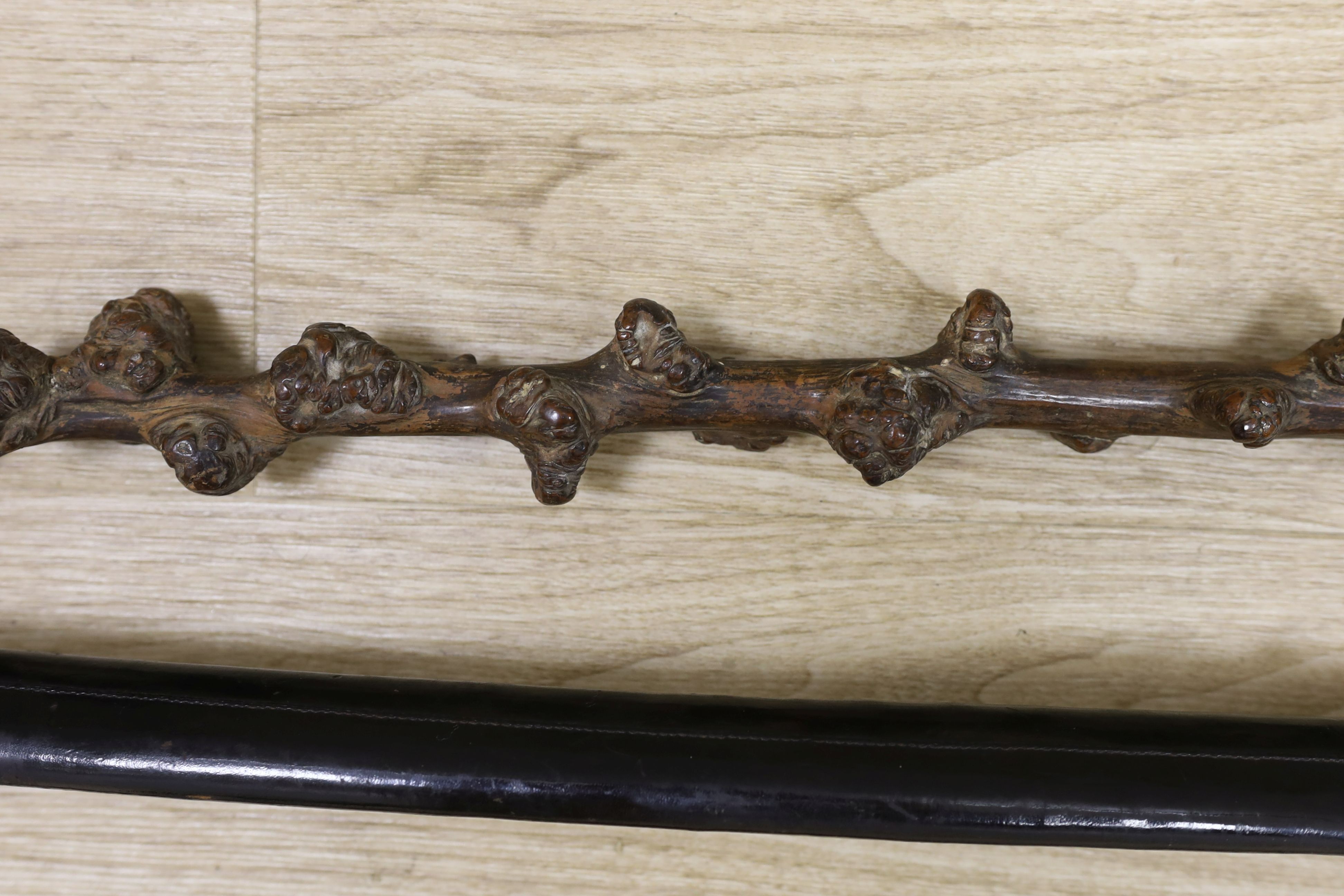 A Victorian officer's sword, two swagger sticks, and a rootwood walking cane (4)